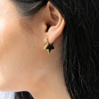 Gold star-shaped earring worn by a person with dark hair - Seol Gold