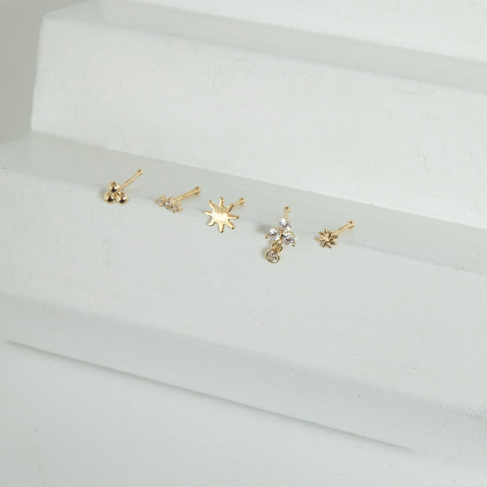 Set of solid gold gold nose studs on a white surface - seolgold