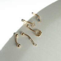 9ct solid Gold nose studs with gemstones on a light gray surface - seolgold