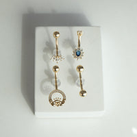 Set of gold belly button rings with gemstones on a white background - seolgold