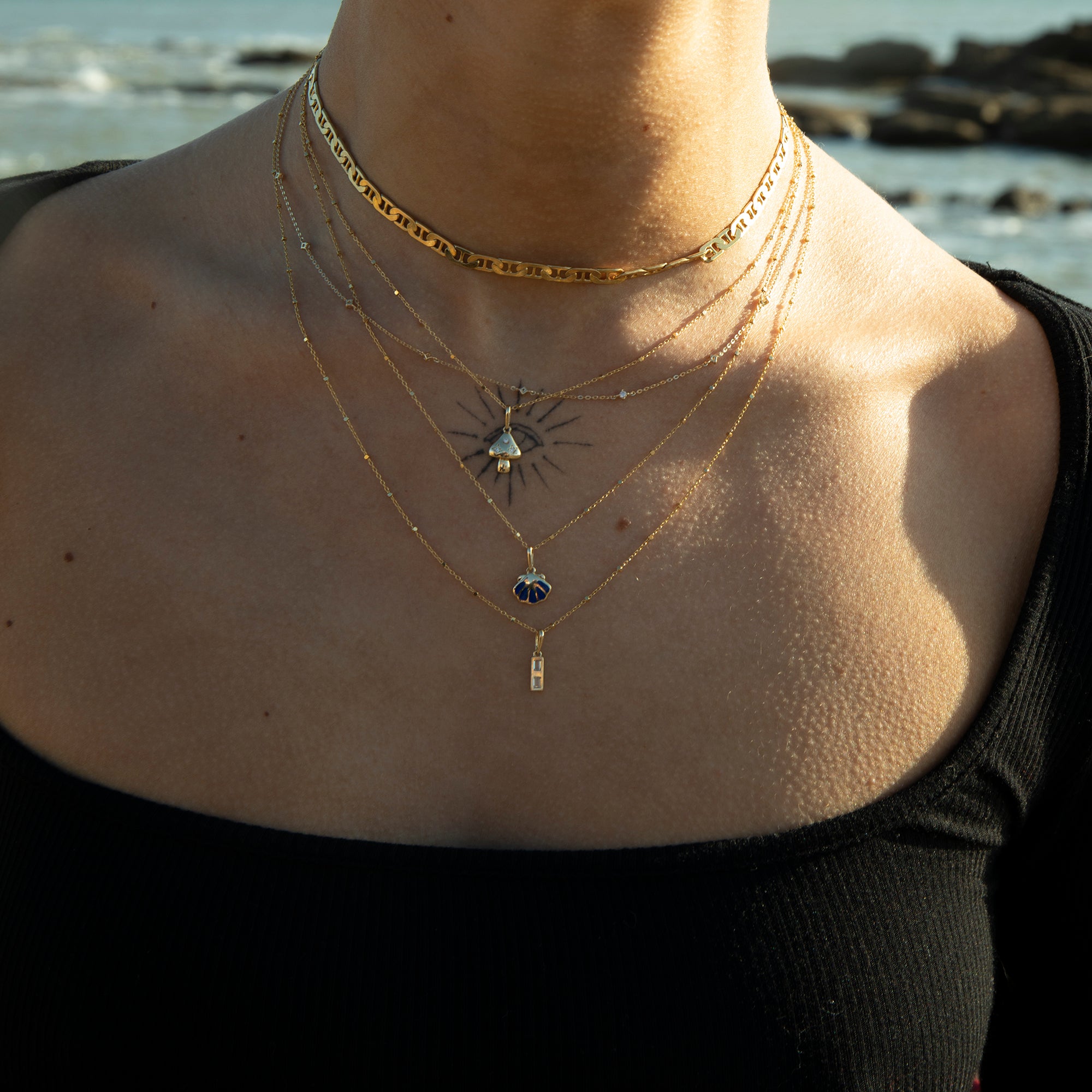Necklace with star-shaped pendant worn by a person against a blurred natural background - seolgold