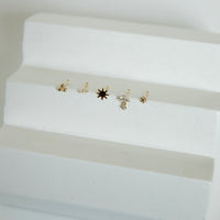 Set of small gold nose studs on a white surface - seolgold