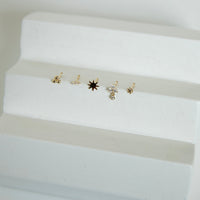 Set of small gold nose studs on a white surface - seolgold