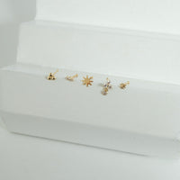Set of gold nose stud on a white stand with a white background - seolgold