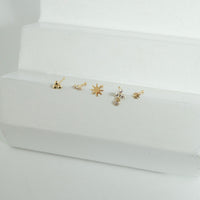 Set of gold nose stud on a white stand with a white background - seolgold