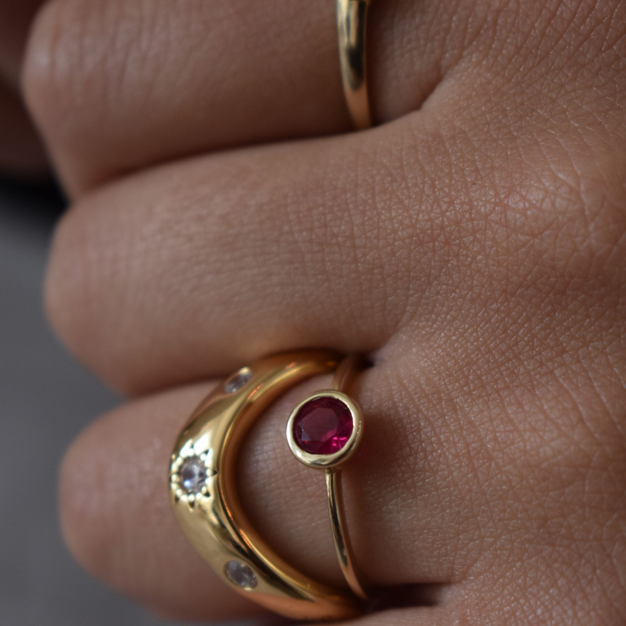 Gold ring with a red ruby gemstone on a finger - seolgold