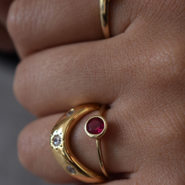 Gold ring with a red ruby gemstone on a finger - seolgold