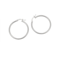 A pair of polished silver hoop earrings with a hinged clasp, displayed on a clean white background - seolgold