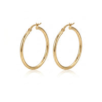 A pair of polished gold hoop earrings with a hinged clasp design, displayed on a clean white background with a soft reflection underneath - seolgold