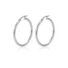 A pair of polished silver hoop earrings with a hinged clasp, displayed on a clean white background with a soft reflection underneath - seolgold