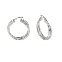 A pair of silver-toned triple-band hoop earrings on a plain white background - seolgold