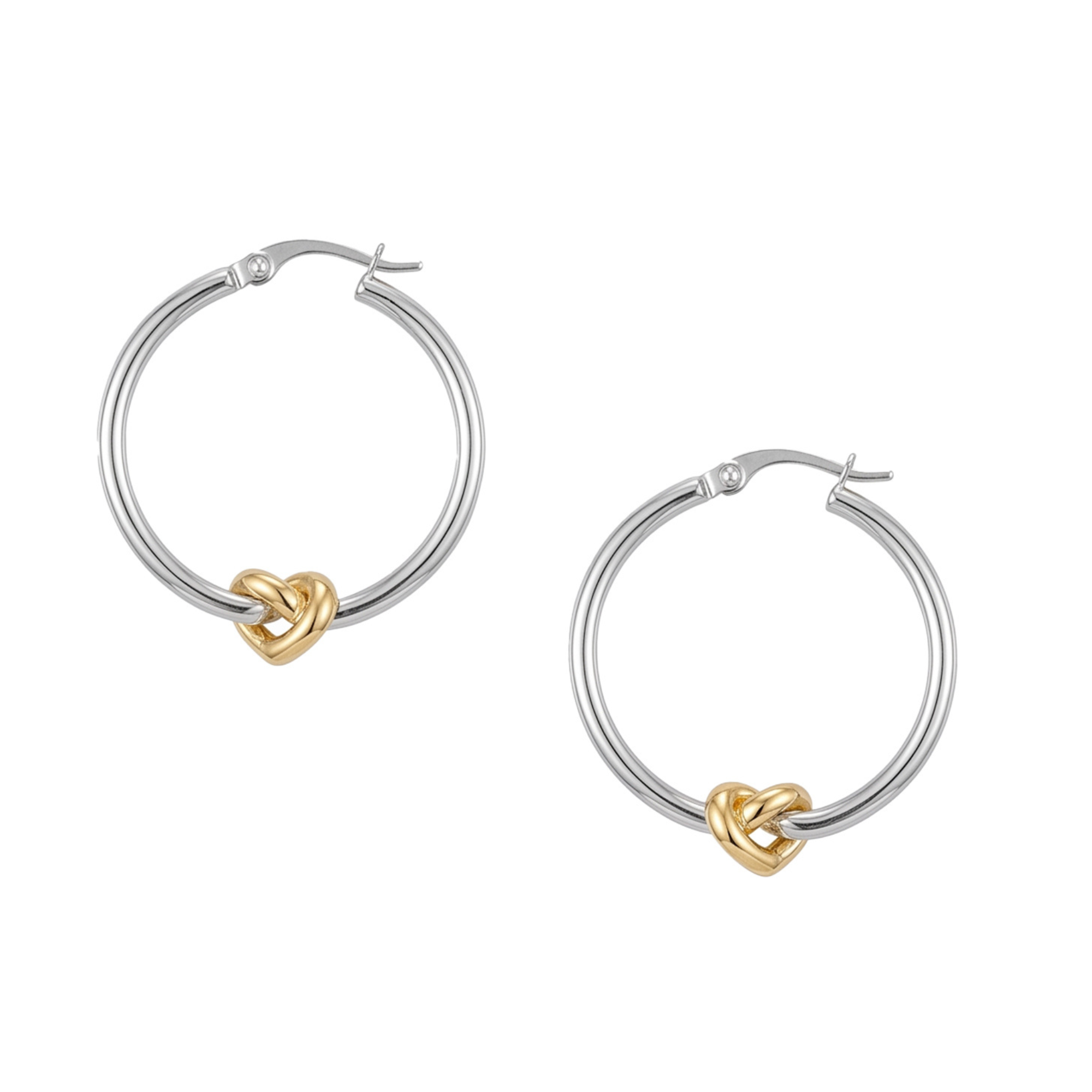 A pair of silver hoop earrings with a small gold heart-shaped knot at the bottom of each hoop, shown on a plain white background. Seol gold