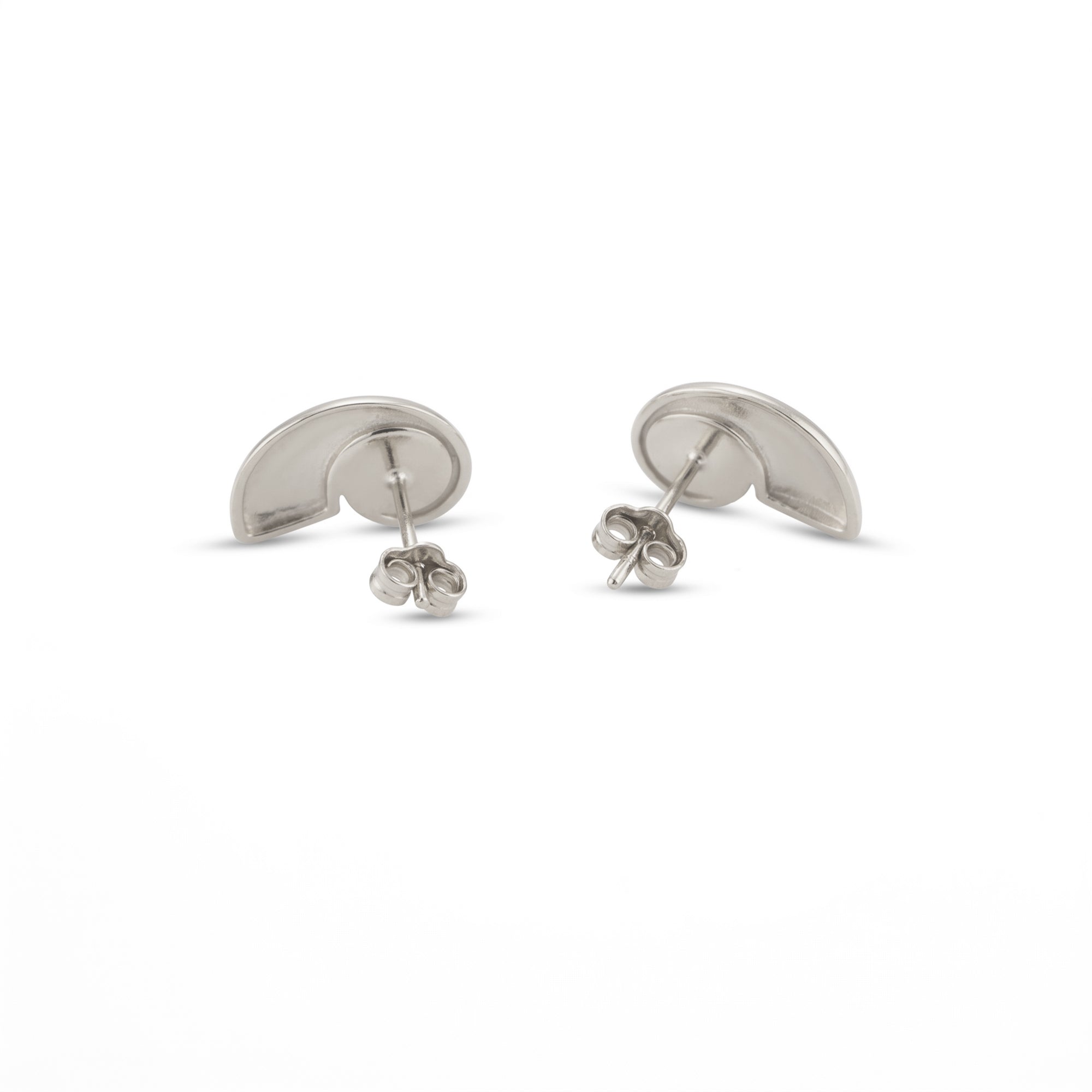 A pair of silver shell shaped stud earrings shown from the back on a clean white background - seolgold