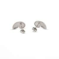 A pair of silver shell shaped stud earrings shown from the back on a clean white background - seolgold