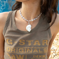 Person wearing a shell pendant necklace on a G-Star Originals tank top with a blue background - seolgold