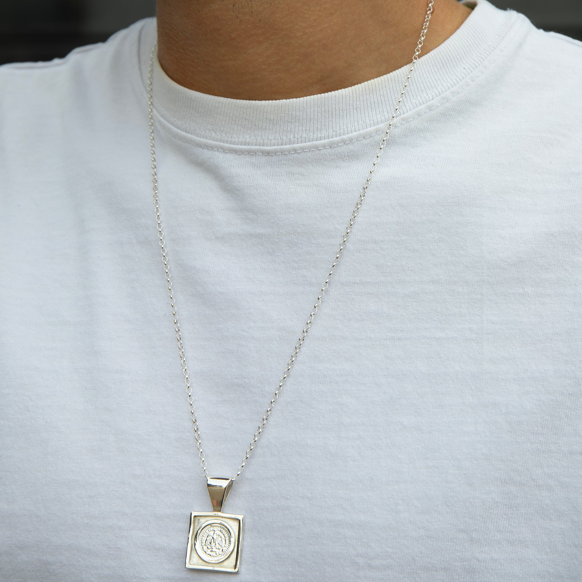 Silver necklace with a pendant on a white shirt - seolgold