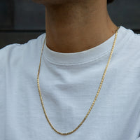 Gold chain necklace worn by a person on a plain background - seolgold