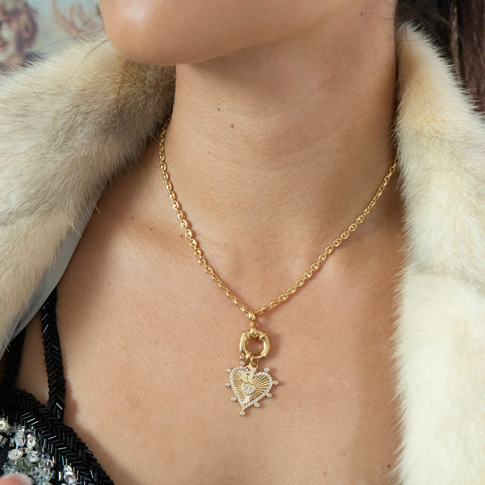 Gold necklace with a heart-shaped pendant worn by a person in a fur coat - seolgold