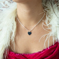 Necklace with a heart-shaped pendant worn by a person with a white fur collar and red garment - seolgold