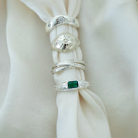 Silver rings with gemstones on a white fabric background - seolgold