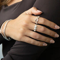 Hand wearing a silver shell ring - seolgold
