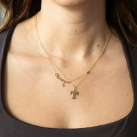 Gold necklace with letter 'T' pendant on a person wearing a brown top - seolgold