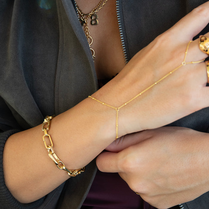 Close-up of a person wearing gold bracelets and a necklace - seolgold