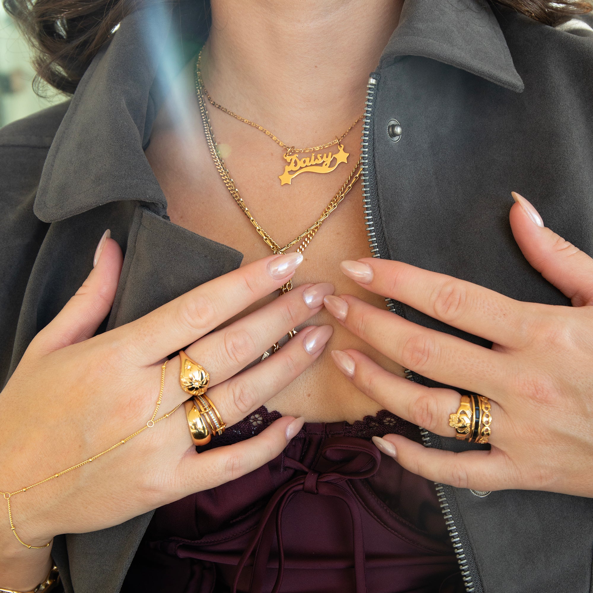 Close-up of a person wearing gold jewelry including rings and necklaces - Seolgold