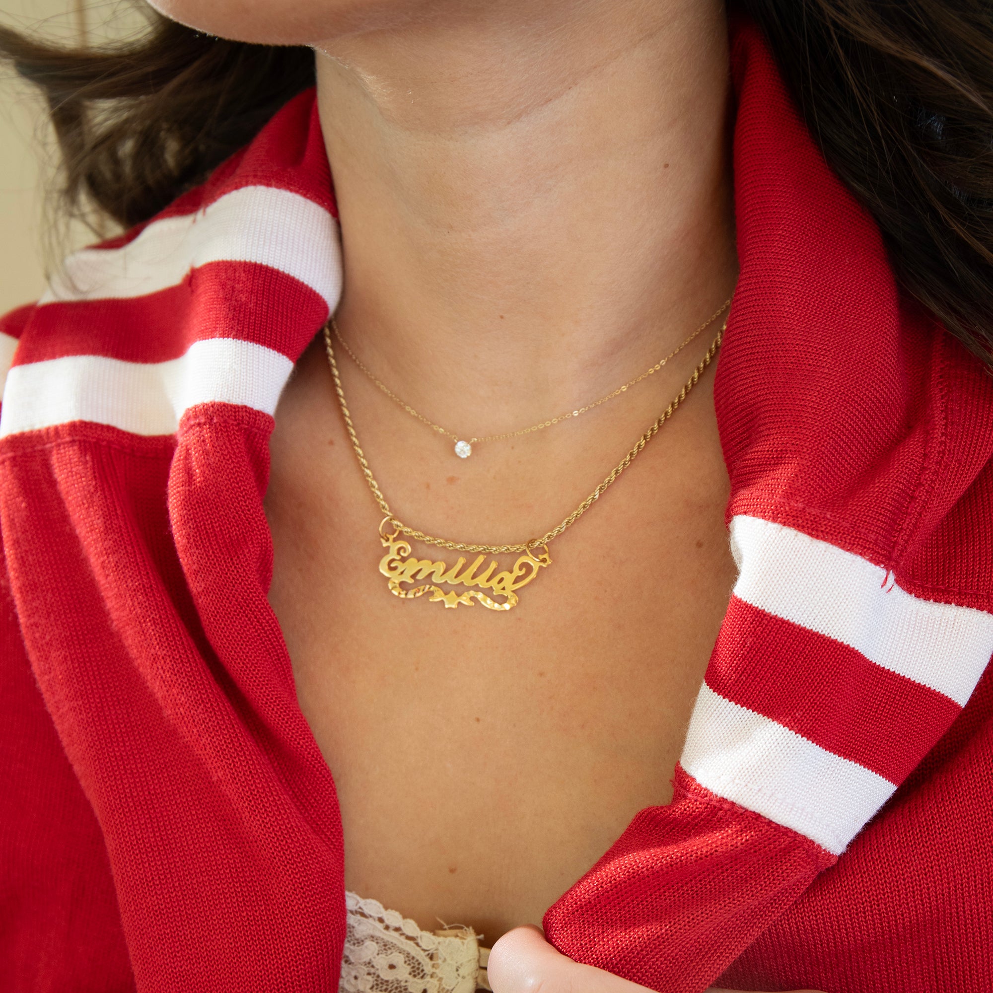 Person wearing a gold necklace with 'Emilia' on it, against a red and white striped background -  18ct Gold Vermeil Custom Script Star Name Pendant - seolgold