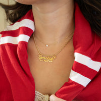 Person wearing a gold necklace with 'Emilia' on it, against a red and white striped background -  18ct Gold Vermeil Custom Script Star Name Pendant - seolgold