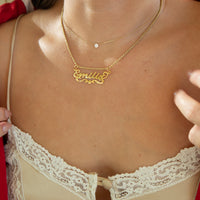 Gold necklace with 'emilia' name pendant on a person wearing a lace vest -  18ct Gold Vermeil Custom Script Star Name Pendant - seolgold