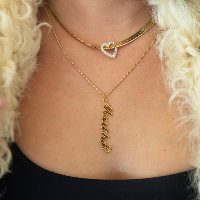 Gold necklace with a heart pendant and a 'Martha' pendant on a person with blonde hair - seolgold
