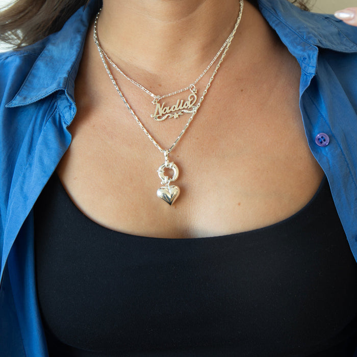 Close-up of a person wearing a silver necklace with a heart pendant and a blue shirt - Sterling Silver Barleycorn Chain - seolgold
