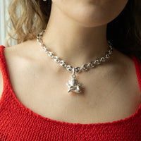 Silver chain necklace with a pendant worn by a person in a red top - seolgold