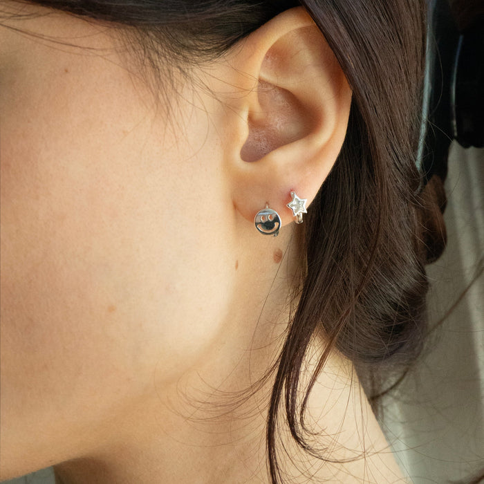 Close-up of an ear wearing two earrings with a blurred background - seolgold