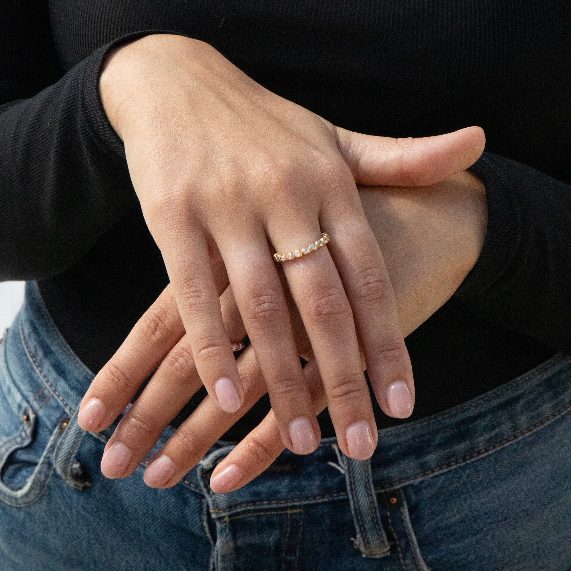 Close-up of hands with a Cz ring on a black background - seolgold
