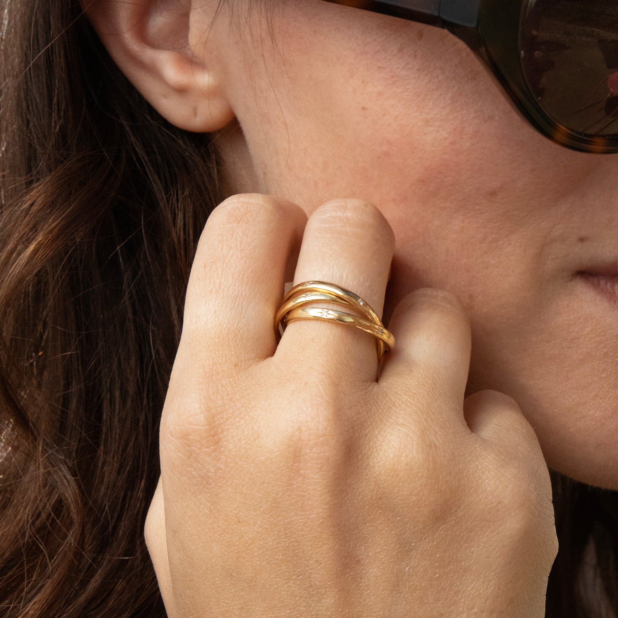 Close-up of a person wearing a gold ring on their finger - seolgold