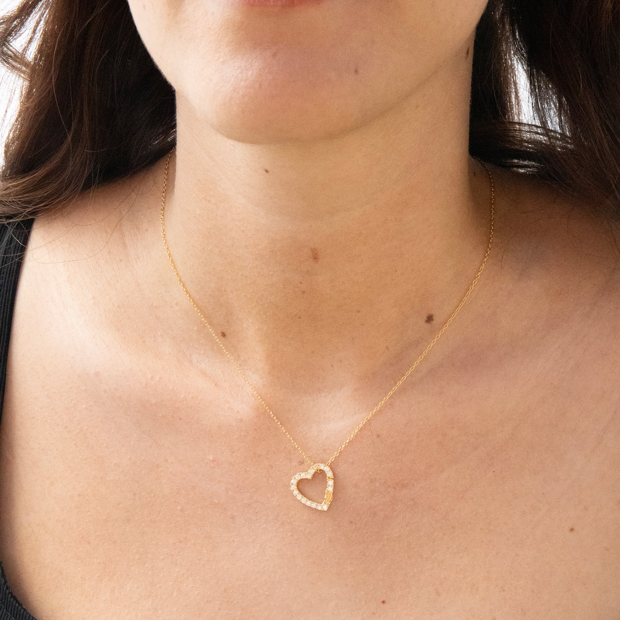 Gold heart-shaped necklace on a person's neck - seolgold