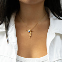 Gold necklace with a pendant worn by a person against a white background - seolgold