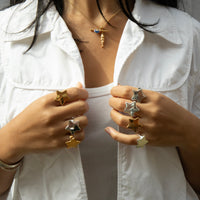 Person wearing star-shaped rings on both hands with a white shirt background - seolgold