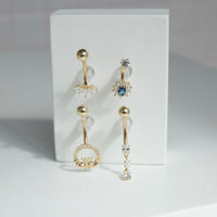 Set of y2k 9ct solid gold belly button rings with gemstones on a white card - seolgold