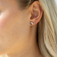 Close-up of an ear wearing two earrings with a blurred background - seolgold