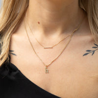 Close-up of a person wearing two gold necklaces - seolgold