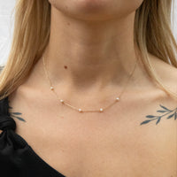 Necklace with small pearls worn by a person with tattoos on their neck and shoulder - seolgold