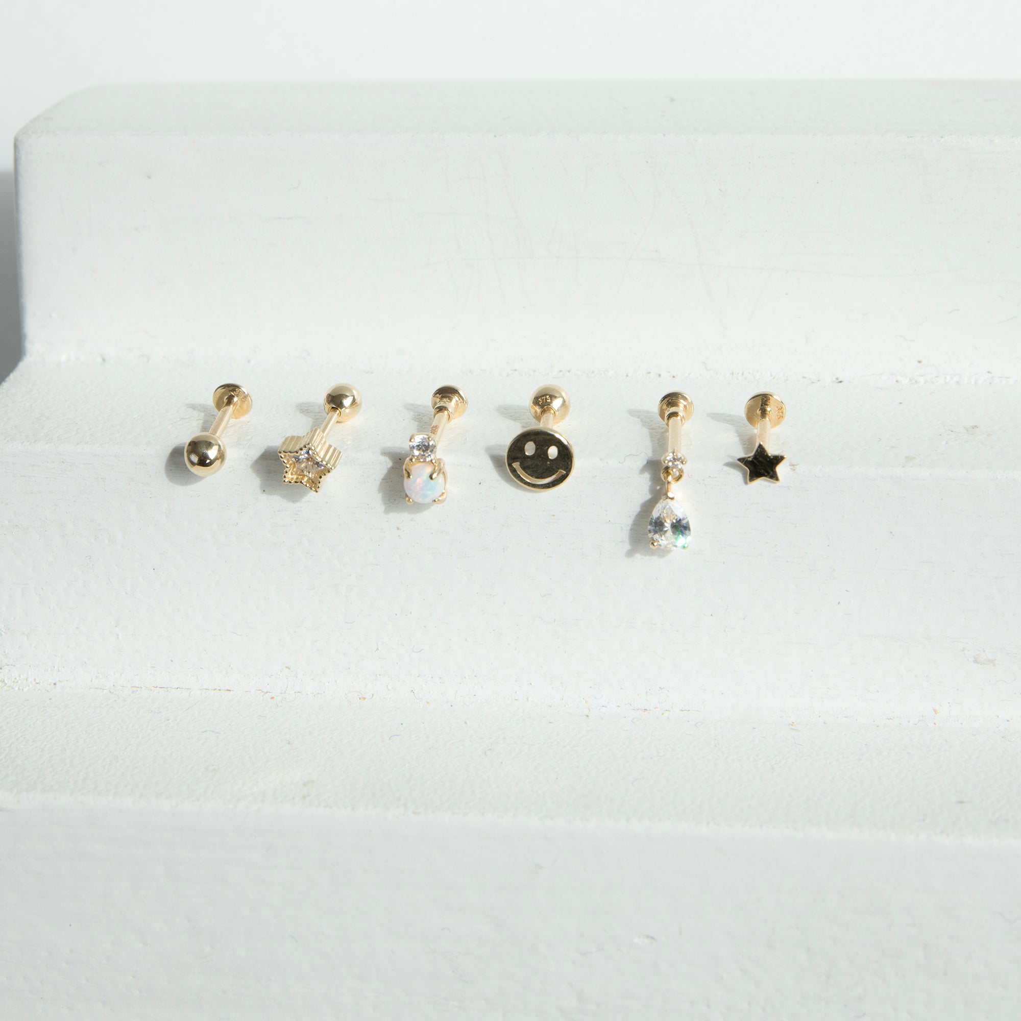 Set of six gold earrings on a white background - seolgold