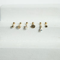 Set of small gold earrings on a white background - seolgold