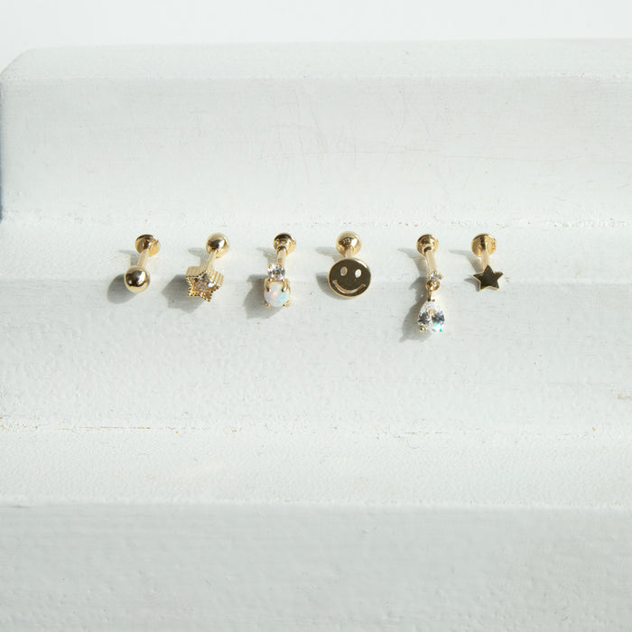 Set of small gold earrings on a white background - seolgold