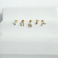 Set of gold and silver earrings on a white cushion - seolgold