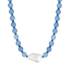 Necklace with blue beads and a clear crystal pendant on a white background