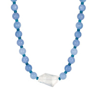 Necklace with blue beads and a clear crystal pendant on a white background